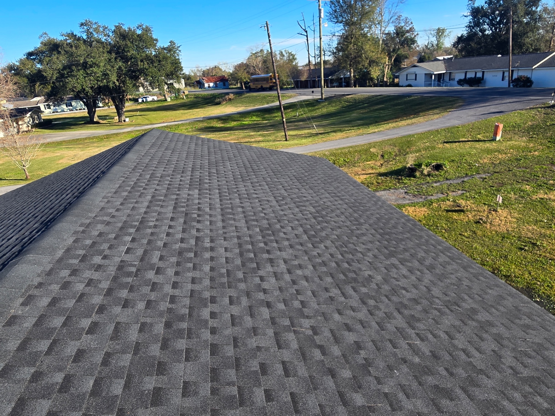 Completed roof surface with new shingles after storm repair