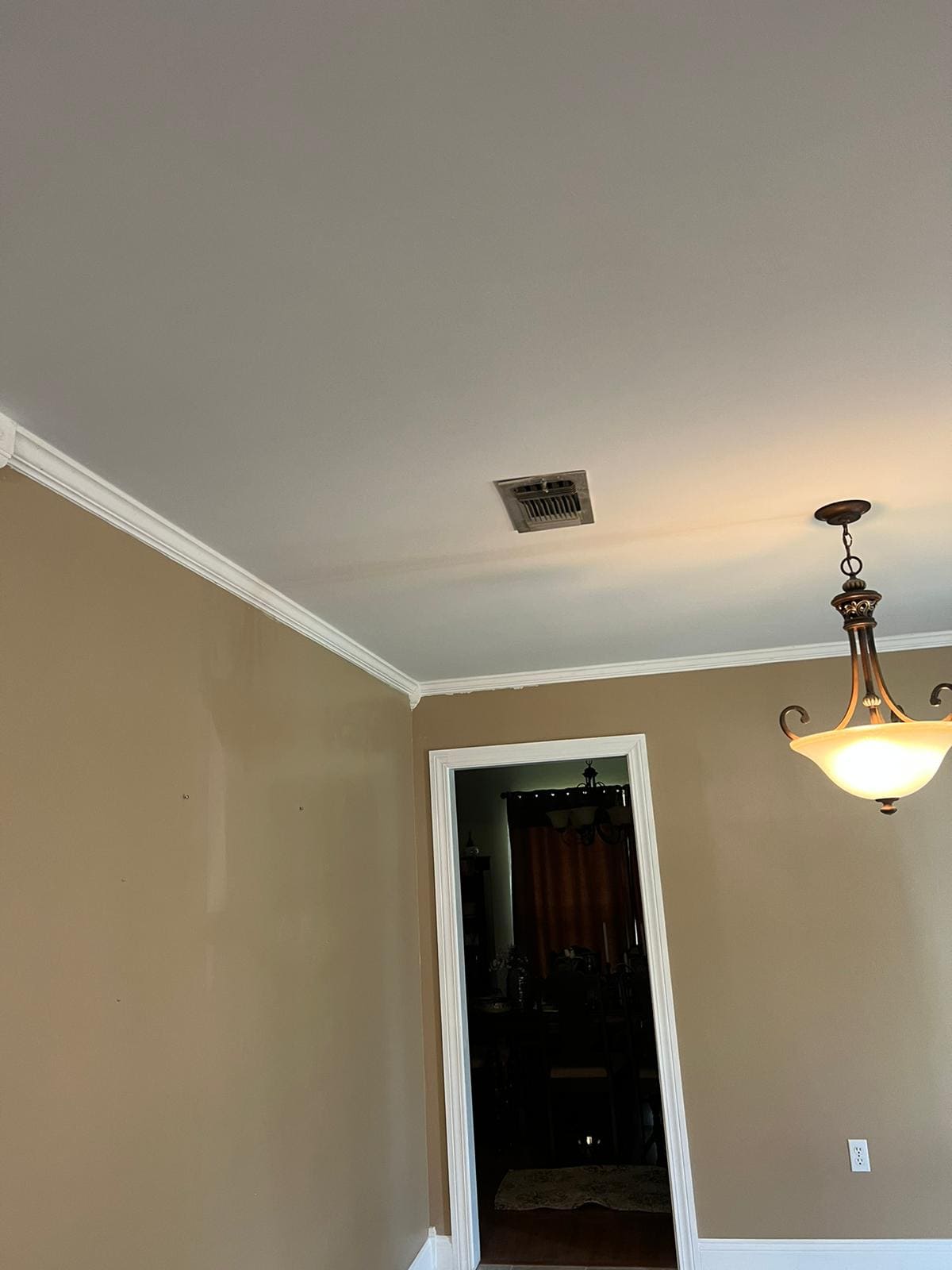 Finished smooth dining-room ceiling with crown molding