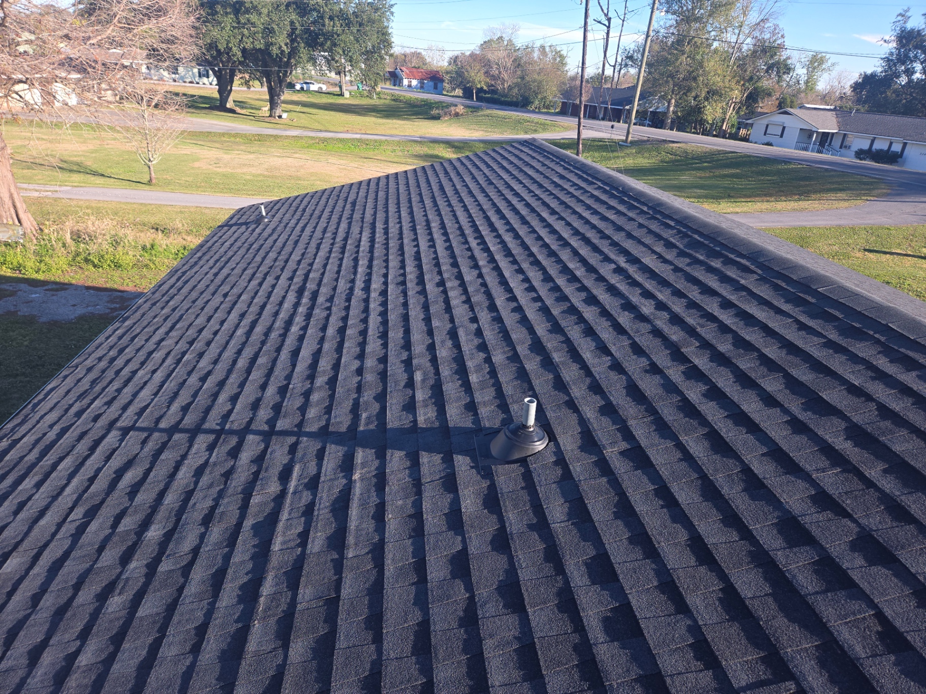 Finished shingle roof from above showing clean new installation