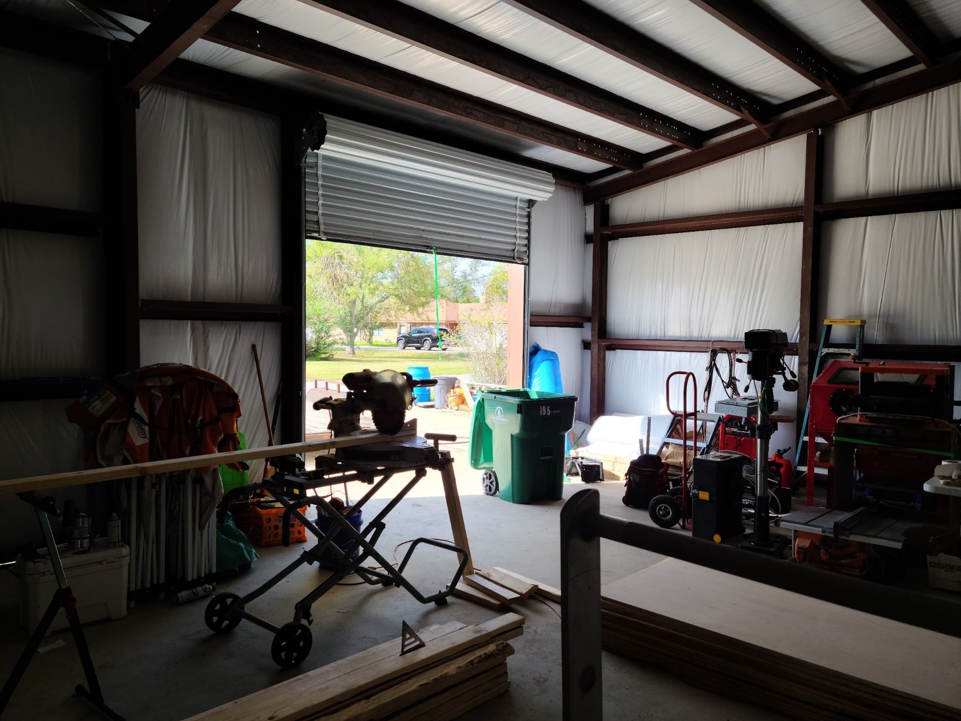Open roll-up door of the completed shop, in daily use