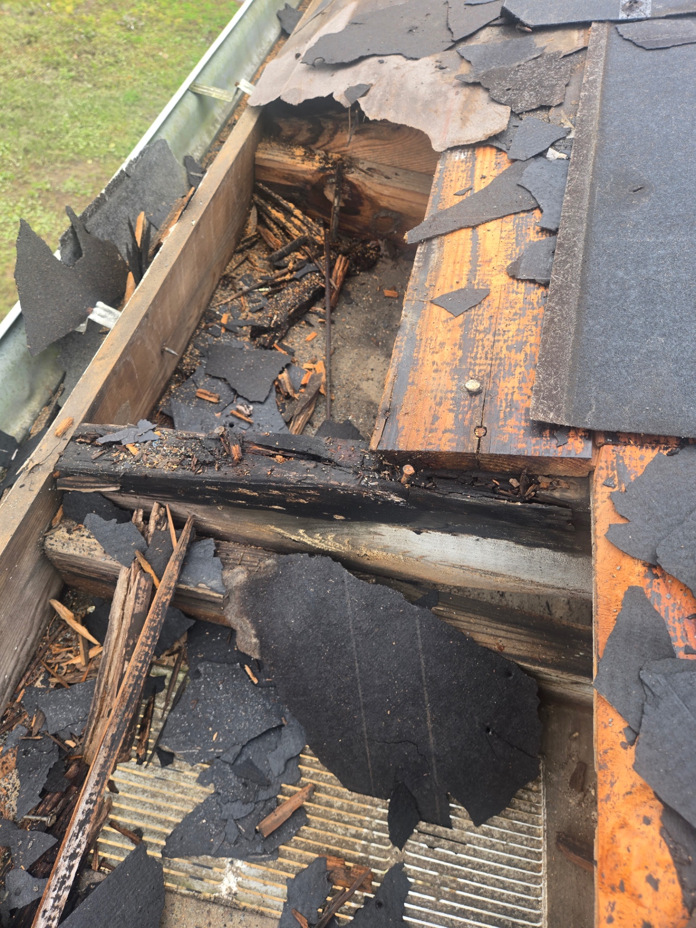 Close-up of severe rot and storm damage inside the roof edge assembly