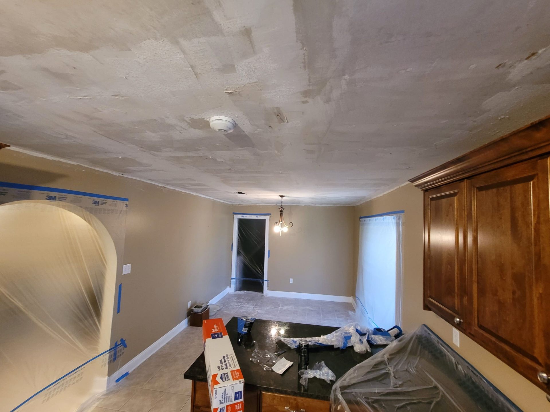 Dining room ceiling prepped for sheetrock repair and popcorn removal