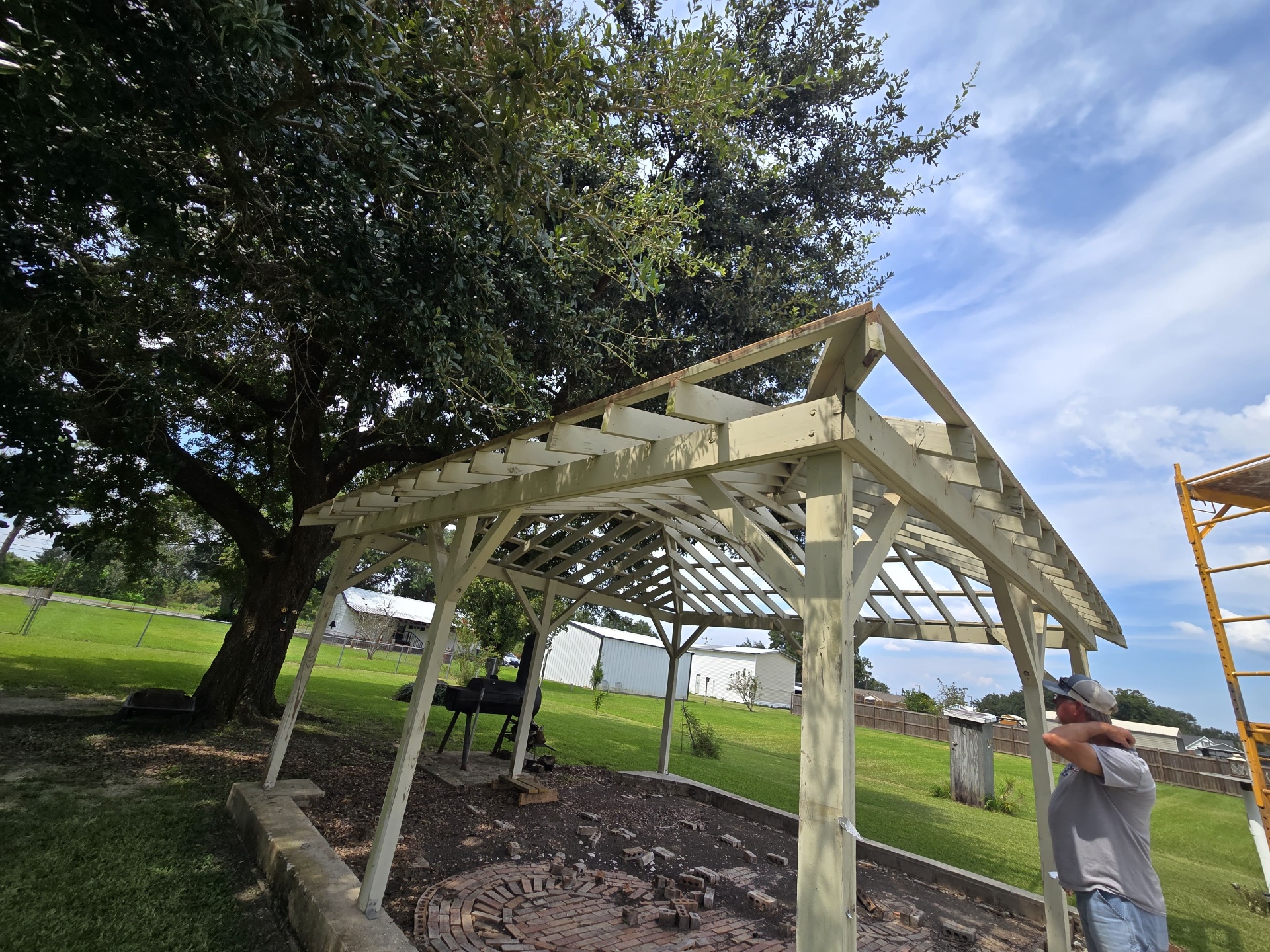 Side view of the existing white pergola structure on the property