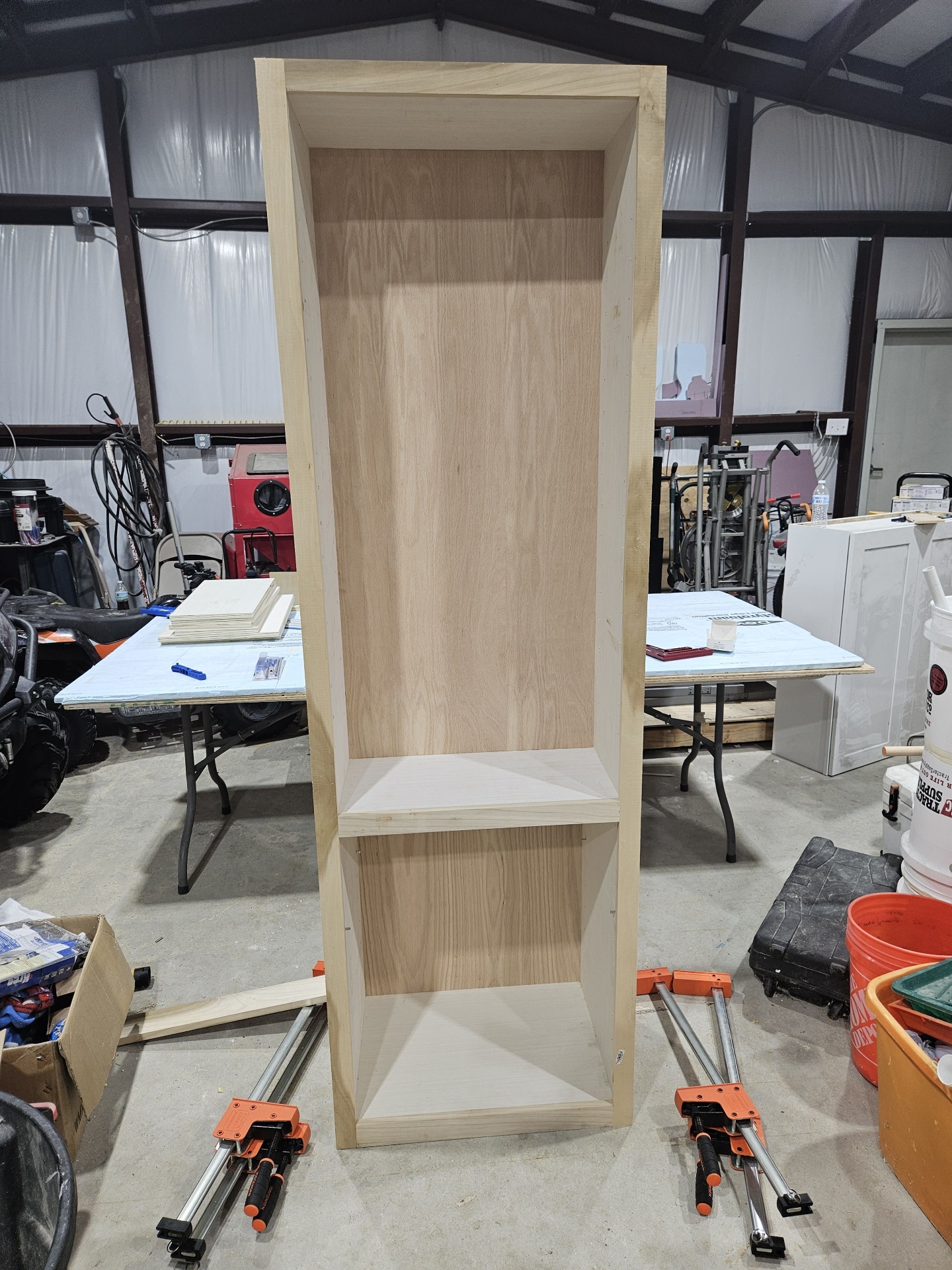 Tall two-bay oak shelf carcass standing in the workshop