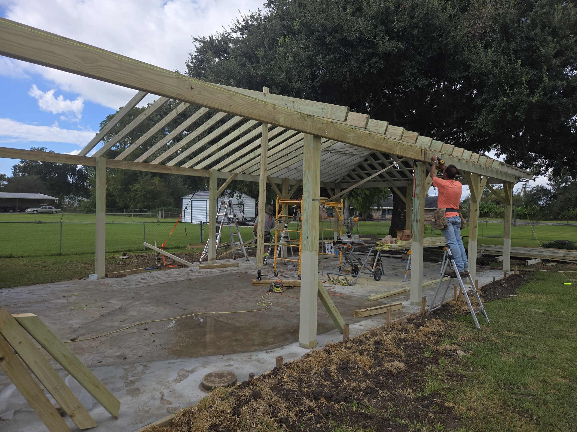 New heavy-timber pavilion frame going up over the concrete slab
