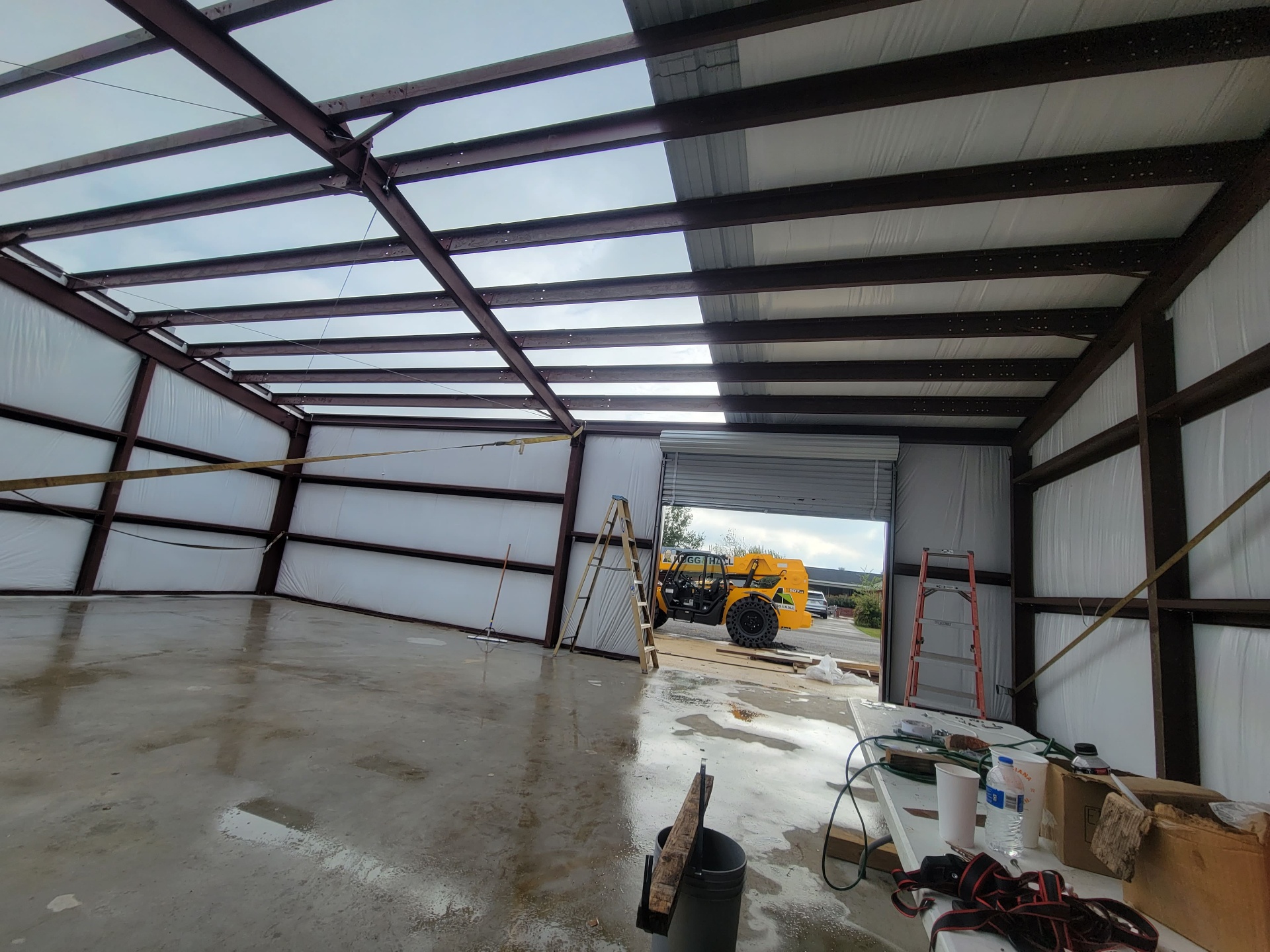 Red-iron steel frame erected over the new slab