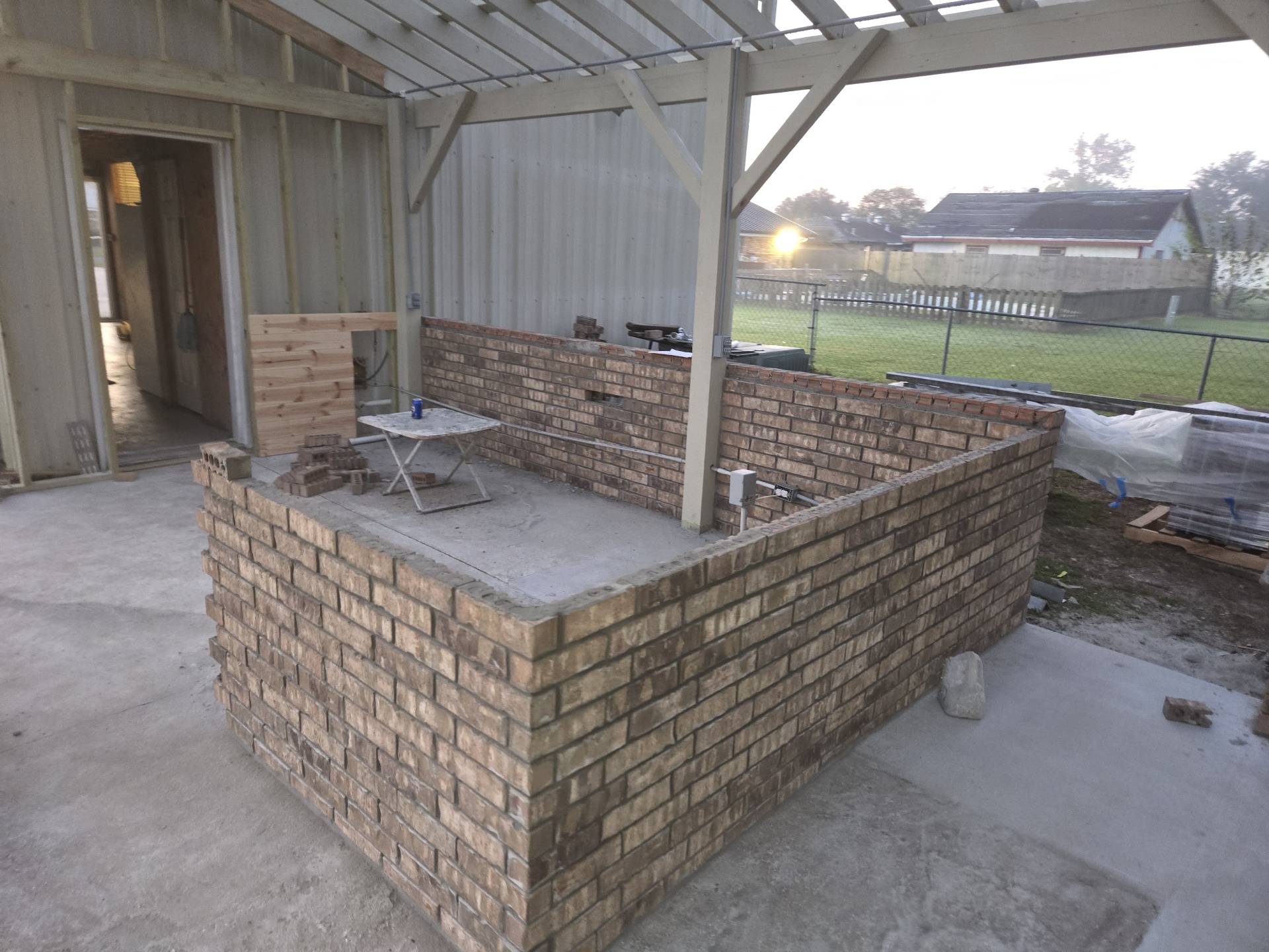 Brick base of the outdoor kitchen island under construction