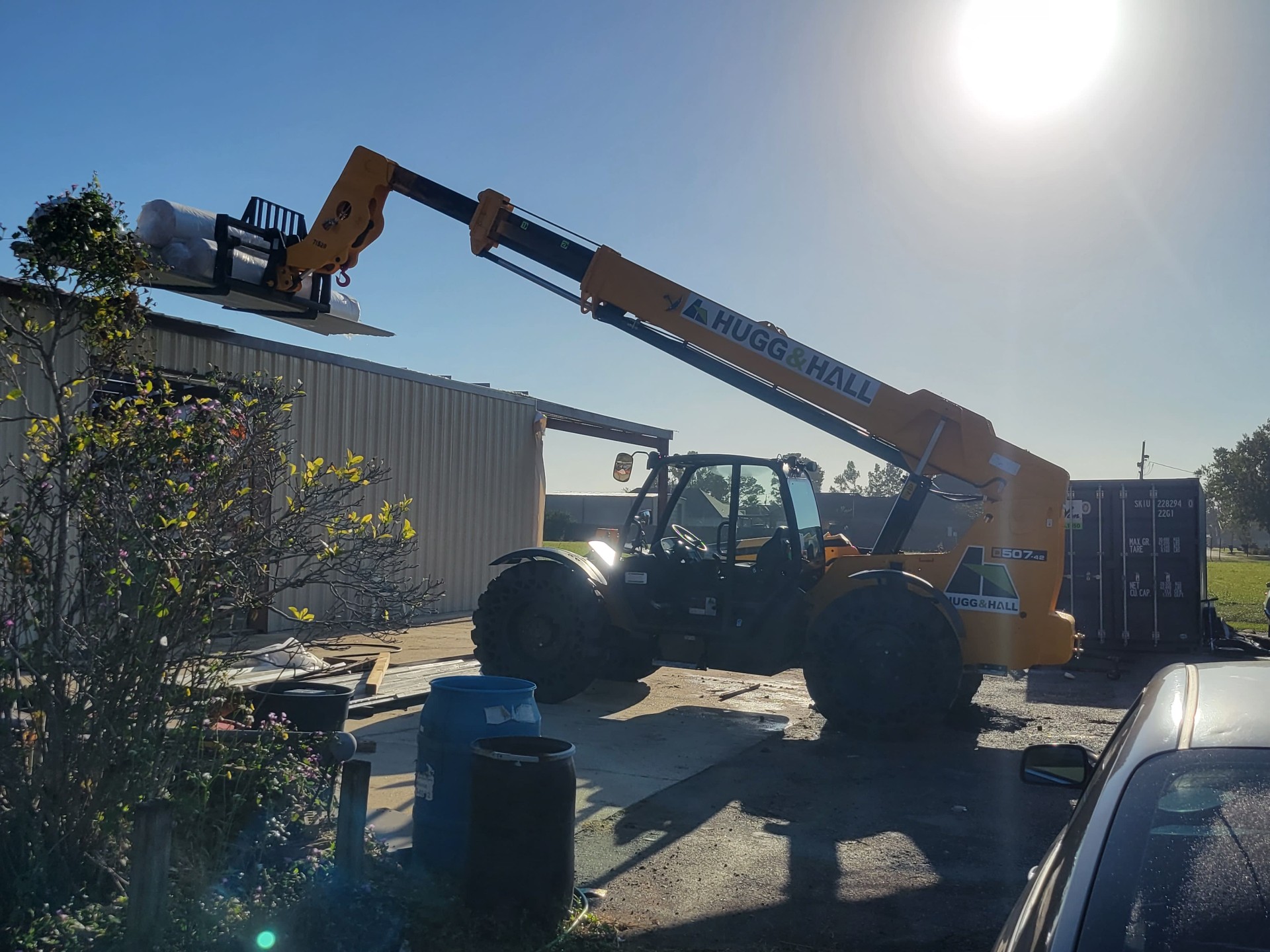 Telehandler delivering insulation rolls to the steel building