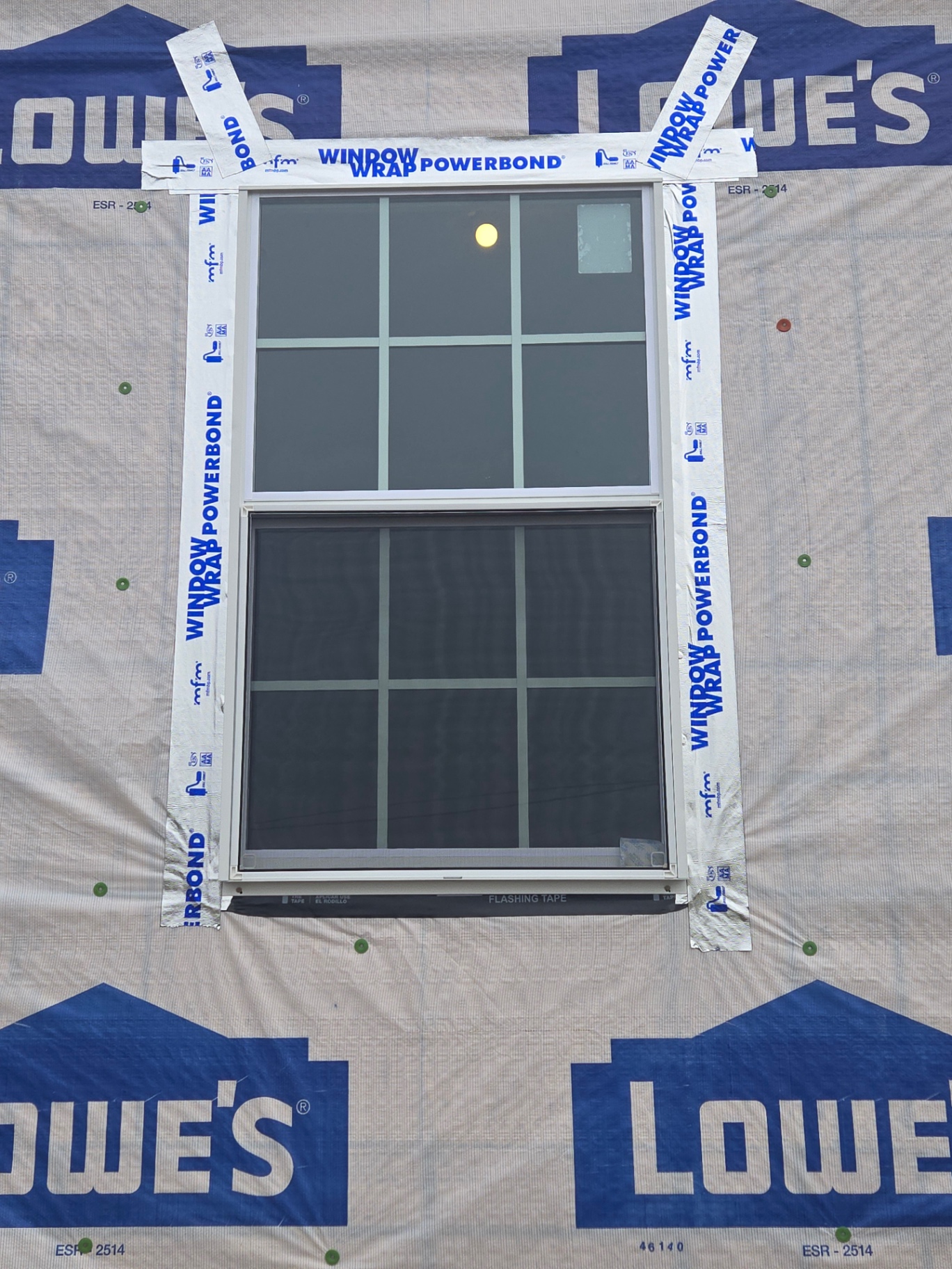 Completed exterior wall with new window and weather barrier